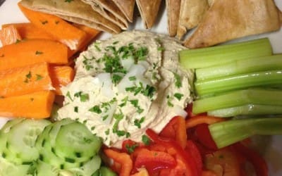 A plate of food with vegetables and pita bread.