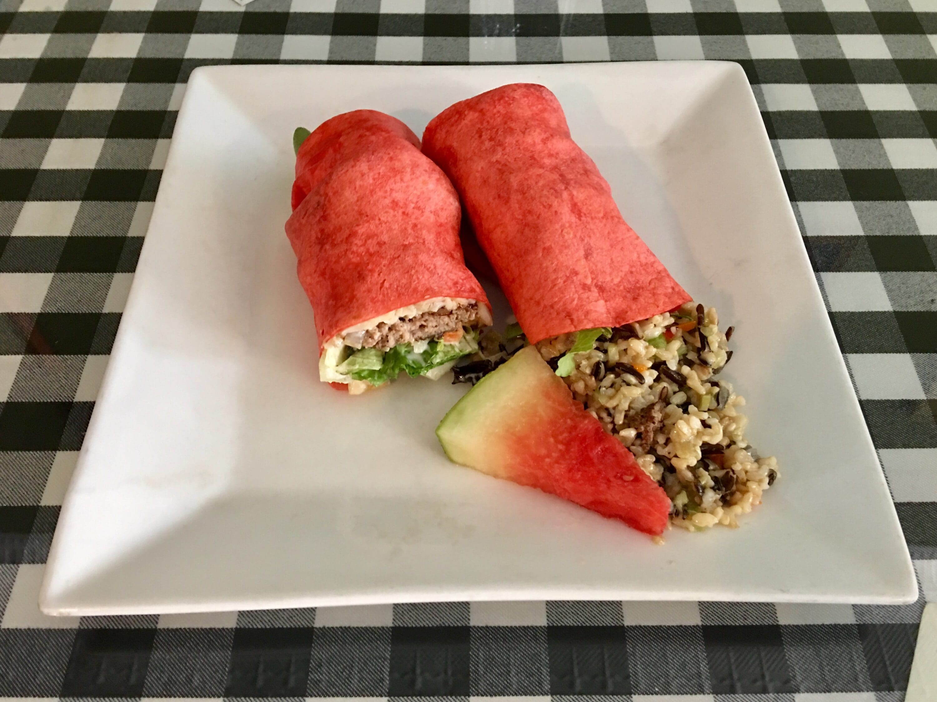 A white plate with two sandwiches on it